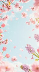 Spring blossom: pink flowers and petals against a blue sky