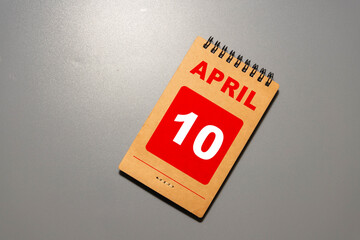 10 April calendar on wooden table with customizable space