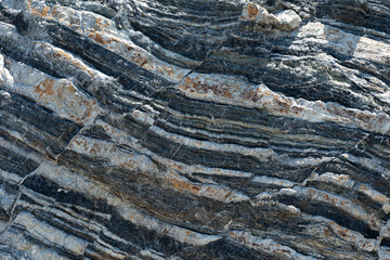 Compressed rock layers formation in various colors and thicknesses, on south central coast of the...