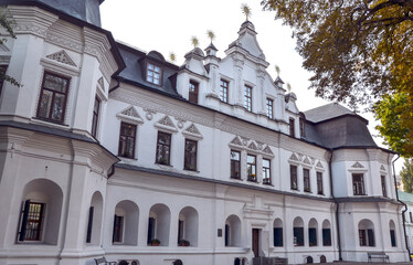 Impressive architectural gem of Metropolitan Residence in Kyiv built in the Baroque style, features white facade adorned with intricate details, arched windows, and prominent central entrance
