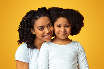 Children Adoption Concept. Happy Black Woman Posing With Her Foster Child, Holding Hands And Cuddling With Daughter On Pink Background