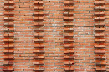 Exterior brick wall with protruding bricks at intervals pattern background