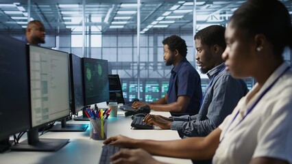 Cybersecurity specialists in server room trying to protect equipment from hacker stealing data....