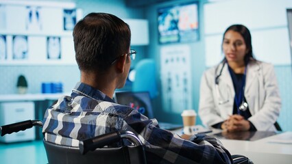 Specialist and patient discussing diagnostic results in a modern medical office, establishing advanced healthcare technology to present x ray imaging results and MRI scans. Care management. Camera B.