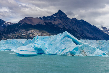 Perito Moreno blue ice glacier national park in Argentina. Huge iceberg and ice walls with cracks,...