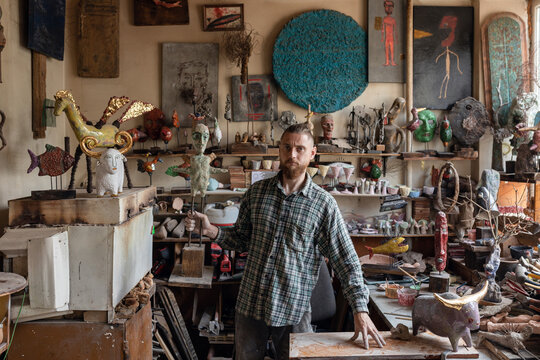 sculptor posing for cameras