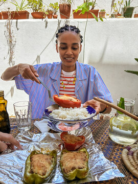 UGC African young woman serving Cape Verde typical food at home