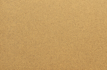 A high-resolution flat texture of gold glitter paper with a uniform color, resembling fine sandpaper. It has an elegant sheen, ideal for adding depth, intricate designs, or delicate details with a shi