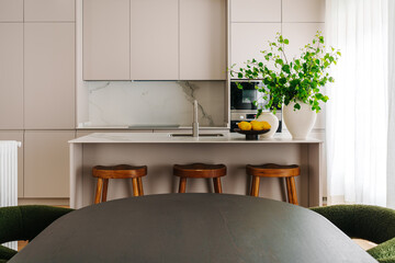 Modern kitchen interior with marble countertops and beige cabinets