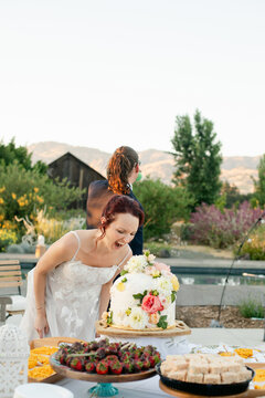 Silly Bride Pretending to Bite Cake