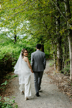 Bride and Groom Walking through Forest