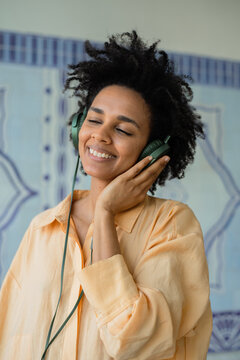 Carefree woman portrait listening music on headset with closed eyes