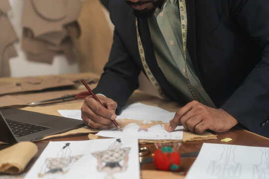 Anonymous Man Drawing Design Sketches In The Tailoring Studio