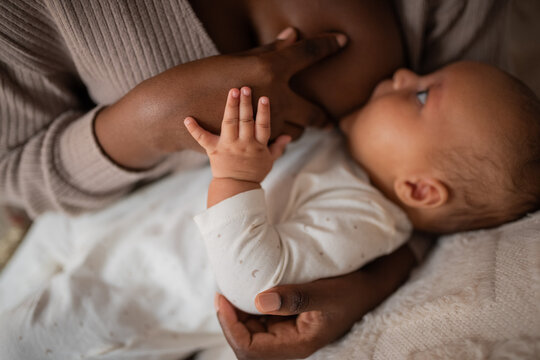Hungry newborn sucking mom's nipple