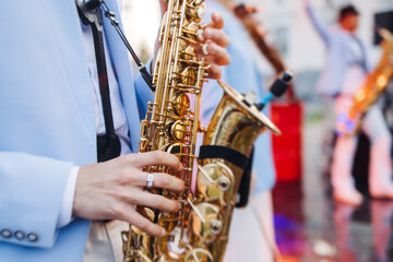 Concert view of saxophonist musician, saxophone sax player with vocalist and musical band during...
