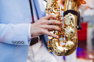 Concert view of saxophonist musician, saxophone sax player with vocalist and musical band during...