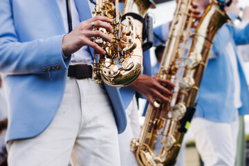 Concert view of saxophonist musician, saxophone sax player with vocalist and musical band during...