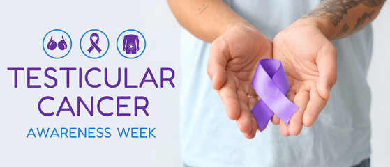 Young man with blue ribbon on light background, closeup. Prostate cancer awareness concept