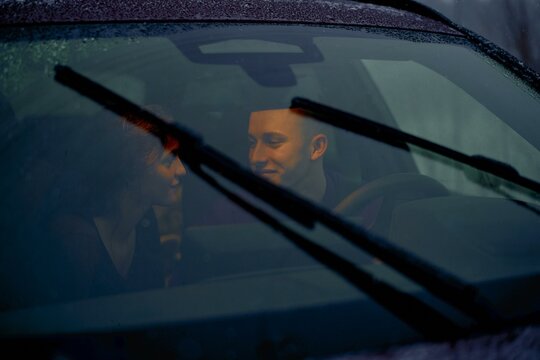 Intimate moment between a couple in a parked car