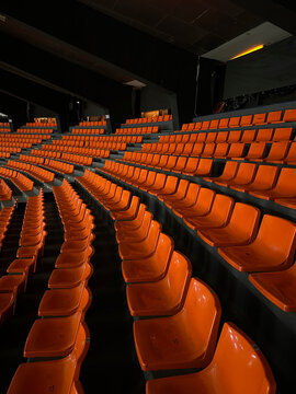 Empty Rows of Orange Stadium Seats
