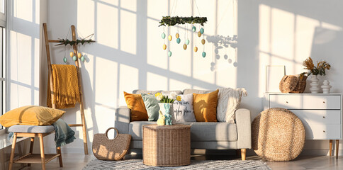 Interior of living room decorated for Easter with sofa, table and ladder