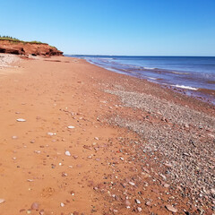 Donahue Beach, St Felix, Kildare, Prince Edward Island (PEI) Canada with red sandstone cliffs and sand against clear blue sky on summer day