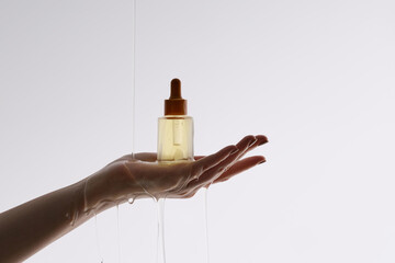 A graceful hand holding a sleek perfume bottle, beautifully illu