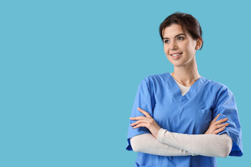 Female medical intern on blue background