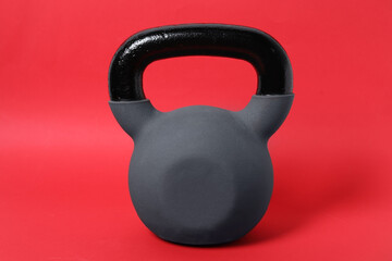 One kettlebell on red background. Sport equipment