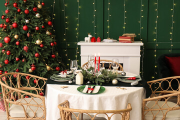 Festive table setting in stylish living room with Christmas tree and fireplace