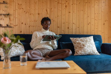 Woman using iPad at home