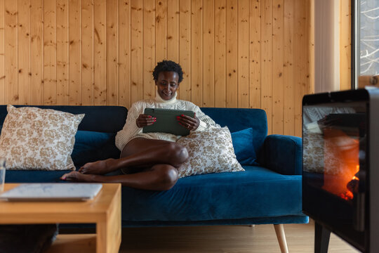 Smiling woman watching funny movie on tablet