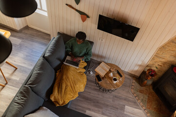  Woman using laptop on couch at home