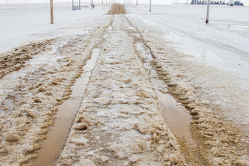 water running over a road during spring thaw