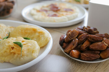 Dates Fruit in a Plate With Other Side Dishes Served on The Table