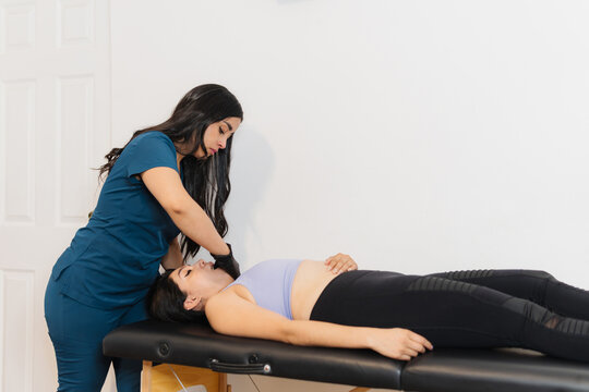 Physiotherapist adjusting his patient's jaw.