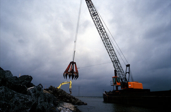 Cranes building a dyke.