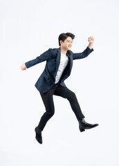Full body image of a young Asian business man jumping on a white background	