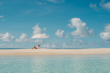 Relaxing under an umbrella on a tranquil beach