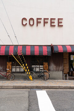 Vintage Coffee Shopfront with Bicycles and Striped Awning