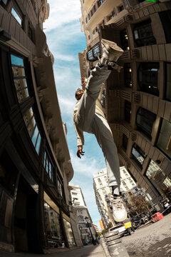 Fisheye angle of man jumping in city street in sunlight