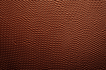 Fototapeta premium Rich brown leather texture with unique pattern, perfect for design projects. This high quality material adds touch of elegance and sophistication to any setting