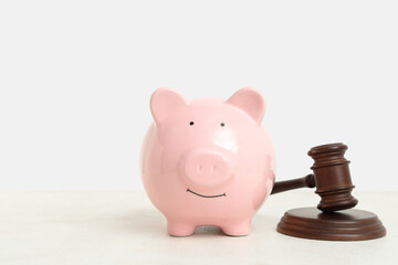 Piggy bank and judge's gavel on white background