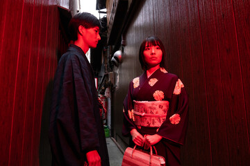 Japanese couple at dark narrow street in Kyoto