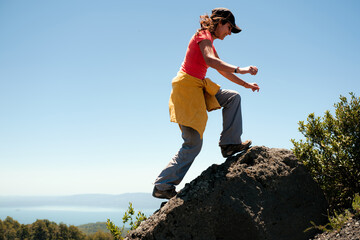 Woman Hiking on Mountain in Bright Sunshine