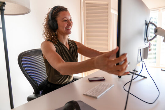 Businesswoman adjusting monitor