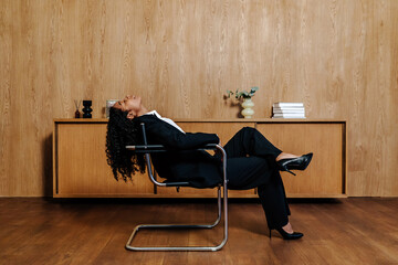 Woman reclining in chair with head tilted back 