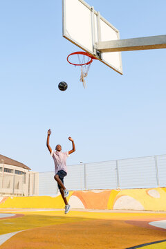 Boy throwing the ball to the basket