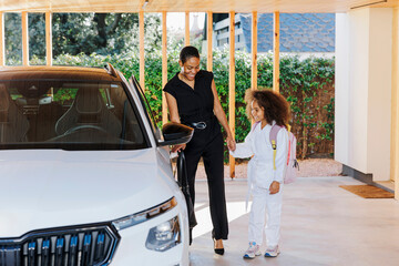 Mother and daughter leaving home for martial arts practice