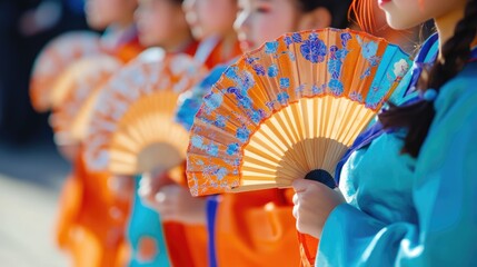 A Woman in a Blue Kimono Holds a Fan